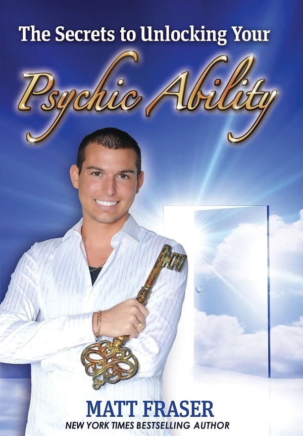 A man holding a large key stands in front of a glowing door with the text "The Secrets to Unlocking Your Psychic Ability" and "Matt Fraser, New York Times Bestselling Author" above and below him.